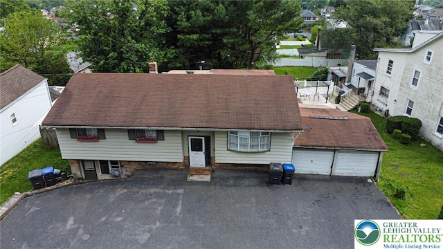 1208 E Susquehanna St, Salisbury Twp, PA 18103 - view of front of property featuring a garage, roof with shingles, and a residential view