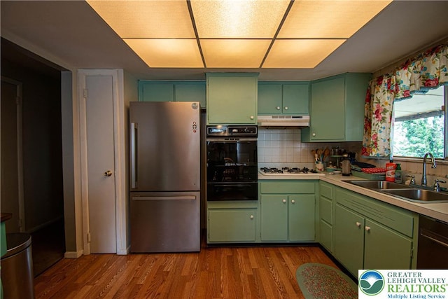 1208 E Susquehanna St, Salisbury Twp, PA 18103 - kitchen featuring freestanding refrigerator, black oven, green cabinets, a warming drawer, and white gas stovetop