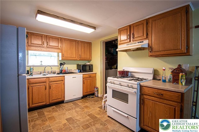1208 E Susquehanna St, Salisbury Twp, PA 18103 - kitchen featuring white appliances, under cabinet range hood, light countertops, and brown cabinets