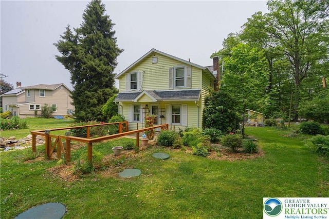 636 School Rd, Plainfield Twp, PA 18064 - view of front of house with a front lawn and a chimney
