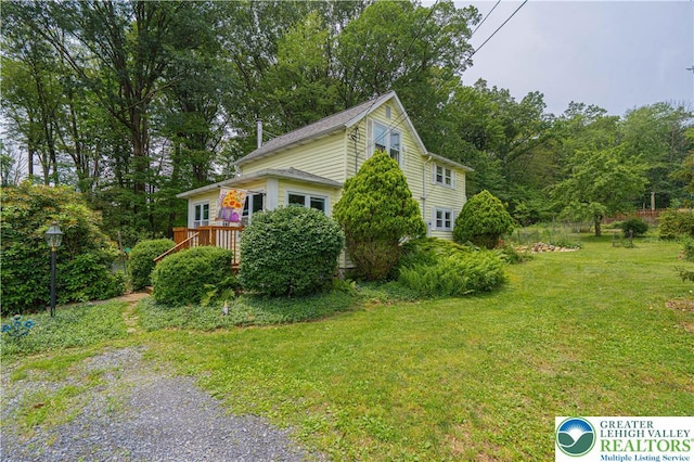 636 School Rd, Plainfield Twp, PA 18064 - view of property exterior featuring a lawn and a deck