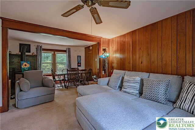 636 School Rd, Plainfield Twp, PA 18064 - living area featuring ceiling fan, carpet flooring, and wood walls