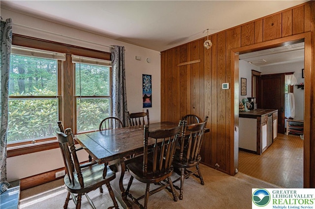 636 School Rd, Plainfield Twp, PA 18064 - dining area featuring wood walls and light colored carpet