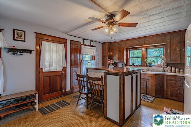 636 School Rd, Plainfield Twp, PA 18064 - kitchen featuring a ceiling fan and a kitchen island