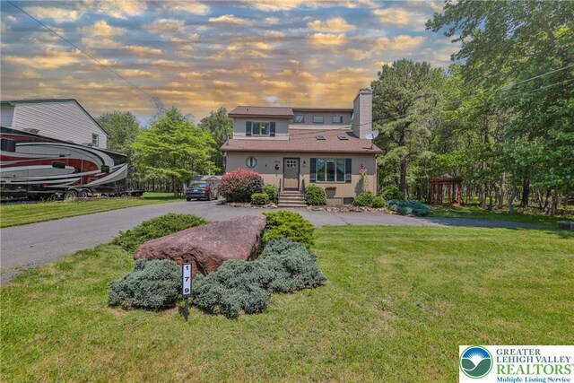 179 Chippewa Trl, Penn Forest Twp, PA 18210 - view of front of property with a chimney, a front yard, and driveway