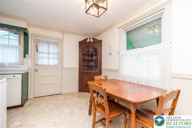 321 Willow Rd, Hellertown Borough, PA 18055 - dining room featuring crown molding, wainscoting, light flooring, and a decorative wall