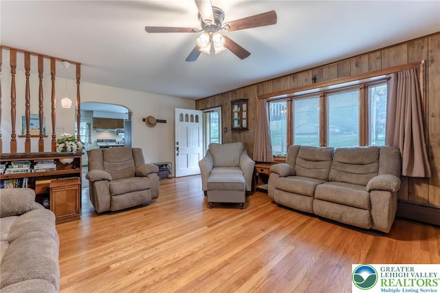 1571 Penn Dr, West Penn Twp, PA 18211 - living area featuring wooden walls, a ceiling fan, and light wood-type flooring