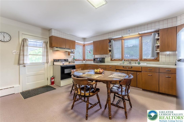 1571 Penn Dr, West Penn Twp, PA 18211 - kitchen featuring white electric range, open shelves, under cabinet range hood, and brown cabinets