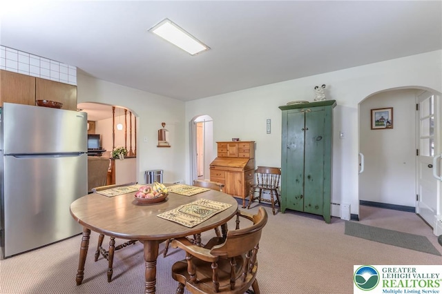1571 Penn Dr, West Penn Twp, PA 18211 - dining space with arched walkways, light colored carpet, and baseboard heating