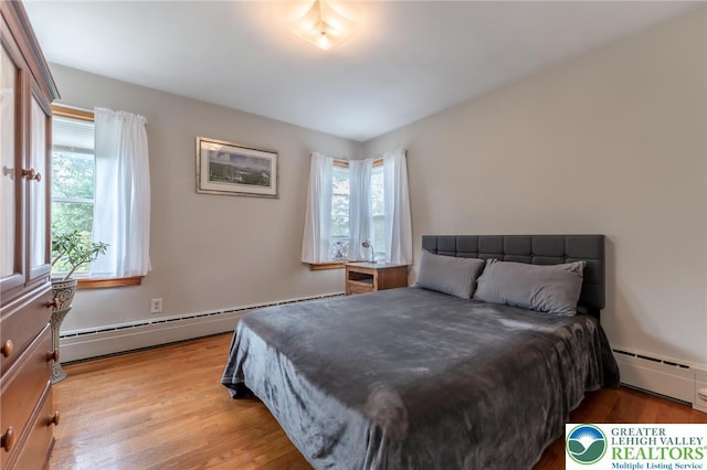 1571 Penn Dr, West Penn Twp, PA 18211 - bedroom featuring a baseboard heating unit and wood finished floors