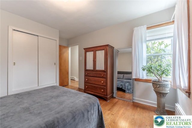 1571 Penn Dr, West Penn Twp, PA 18211 - bedroom with light wood-style flooring, a baseboard heating unit, and a closet