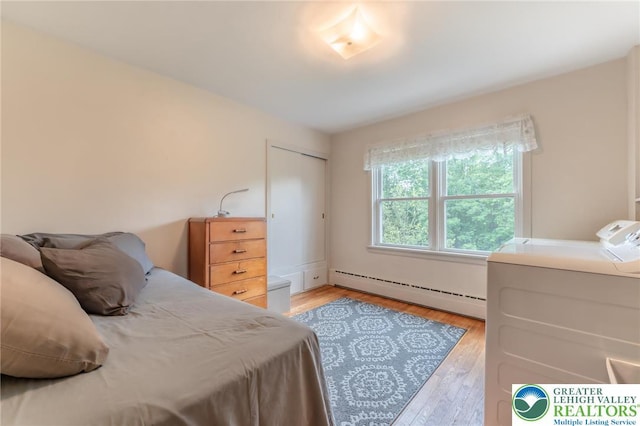 1571 Penn Dr, West Penn Twp, PA 18211 - bedroom with baseboard heating, independent washer and dryer, light wood finished floors, and a closet