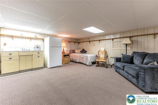 1571 Penn Dr, West Penn Twp, PA 18211 - bedroom featuring freestanding refrigerator, light carpet, wooden walls, and a drop ceiling