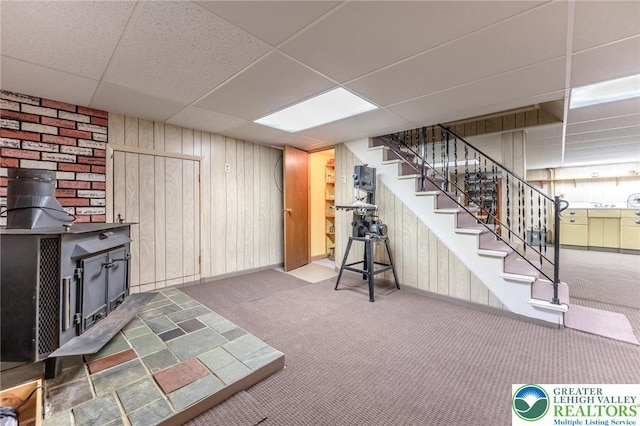 1571 Penn Dr, West Penn Twp, PA 18211 - finished below grade area featuring carpet floors, stairway, wooden walls, a drop ceiling, and a wood stove