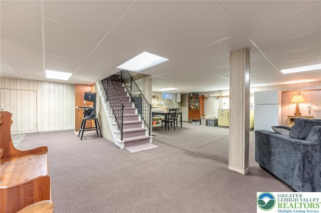 1571 Penn Dr, West Penn Twp, PA 18211 - finished below grade area featuring carpet flooring, wooden walls, stairway, freestanding refrigerator, and a drop ceiling