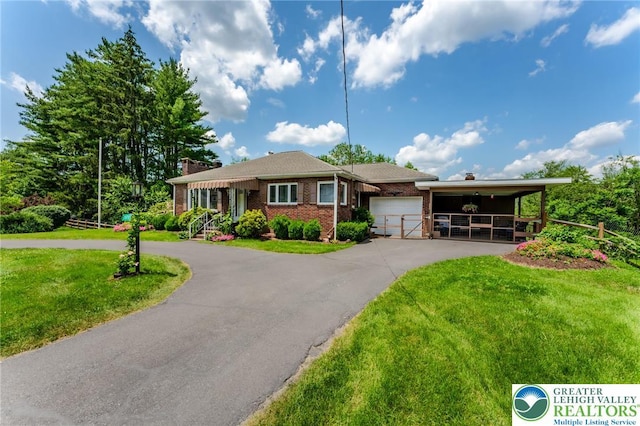 1571 Penn Dr, West Penn Twp, PA 18211 - ranch-style house featuring asphalt driveway, an attached garage, a chimney, and brick siding