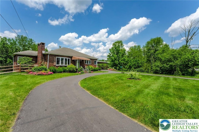 1571 Penn Dr, West Penn Twp, PA 18211 - view of front of home with a chimney and brick siding