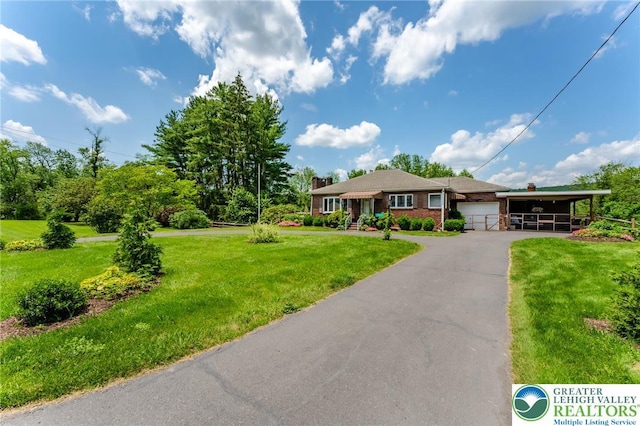 1571 Penn Dr, West Penn Twp, PA 18211 - single story home with a garage, a front yard, brick siding, and a carport