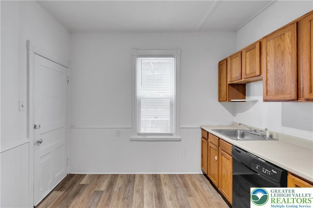 834 Bushkill St, Easton, PA 18042 - kitchen featuring black dishwasher, light wood-style flooring, brown cabinetry, wainscoting, and light countertops