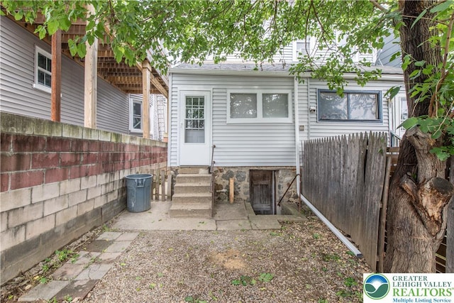834 Bushkill St, Easton, PA 18042 - rear view of house with entry steps and a fenced backyard
