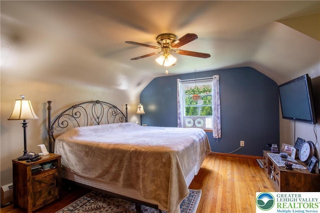 7035 Scenic Dr, Bloomsburg, PA 17815 - bedroom with hardwood / wood-style floors, vaulted ceiling, ceiling fan, and a baseboard heating unit