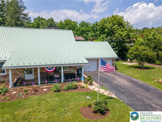 7035 Scenic Dr, Bloomsburg, PA 17815 - a-frame style home with a front lawn, a porch, stone siding, and a metal roof