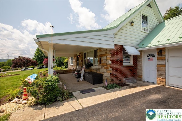 7035 Scenic Dr, Bloomsburg, PA 17815 - view of side of home featuring a metal roof, a standing seam roof, stone siding, and brick siding