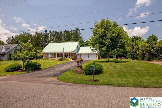 7035 Scenic Dr, Bloomsburg, PA 17815 - view of front of house featuring a detached garage, a front lawn, and a metal roof