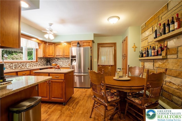 7035 Scenic Dr, Bloomsburg, PA 17815 - kitchen featuring stainless steel fridge, a center island, tasteful backsplash, light wood-style flooring, and light stone counters