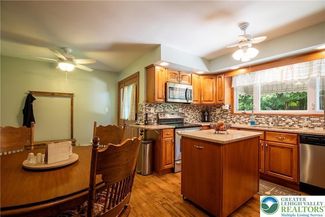 7035 Scenic Dr, Bloomsburg, PA 17815 - kitchen featuring stainless steel appliances, ceiling fan, decorative backsplash, and light wood finished floors