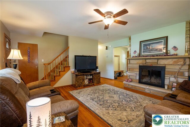 7035 Scenic Dr, Bloomsburg, PA 17815 - living room featuring a ceiling fan, wood finished floors, stairs, and a fireplace