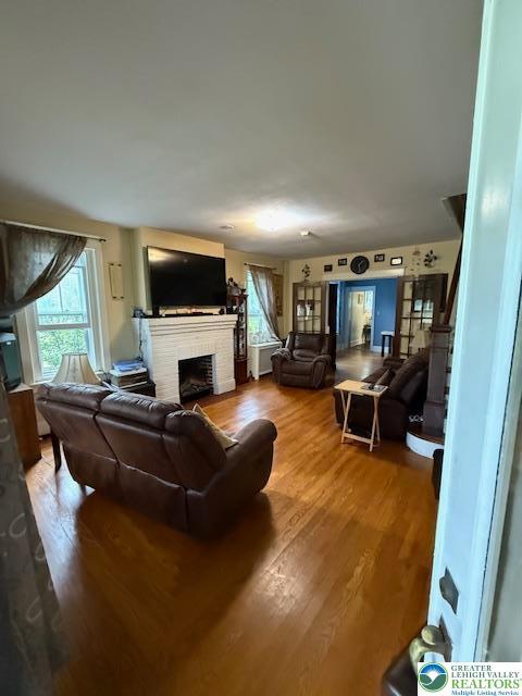 2413 Walbert, South Whitehall Twp, PA 18104 - living area featuring a brick fireplace and wood finished floors