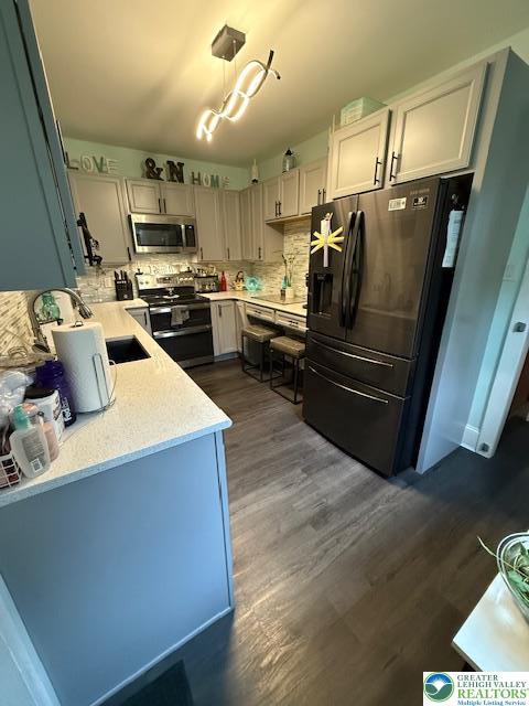 2413 Walbert, South Whitehall Twp, PA 18104 - kitchen with appliances with stainless steel finishes, dark wood-style floors, and tasteful backsplash