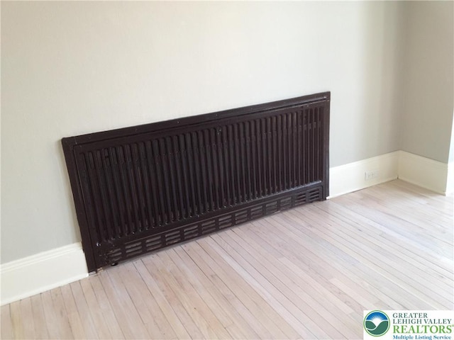 1002 Lehigh St, Easton, PA 18042 - detailed view of radiator heating unit and wood finished floors