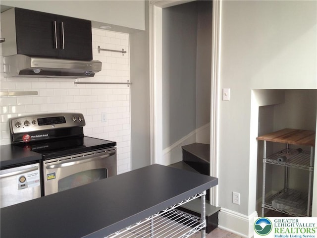 1002 Lehigh St, Easton, PA 18042 - kitchen with stainless steel electric range, exhaust hood, decorative backsplash, and dark countertops