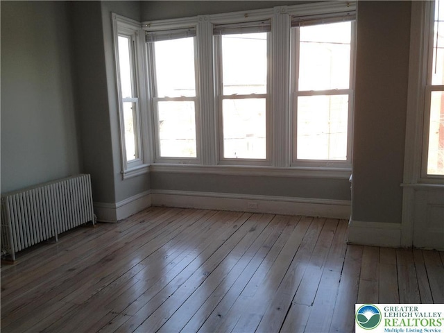 1002 Lehigh St, Easton, PA 18042 - spare room with radiator heating unit and hardwood / wood-style floors
