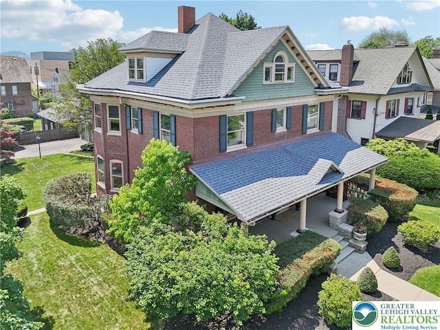 200 W Pierce St, Easton, PA 18042 - back of house featuring brick siding, a chimney, a yard, and covered porch