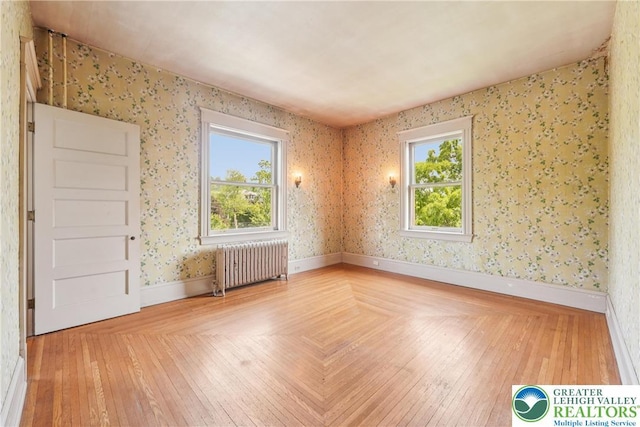 200 W Pierce St, Easton, PA 18042 - empty room featuring radiator heating unit, wallpapered walls, and wood finished floors
