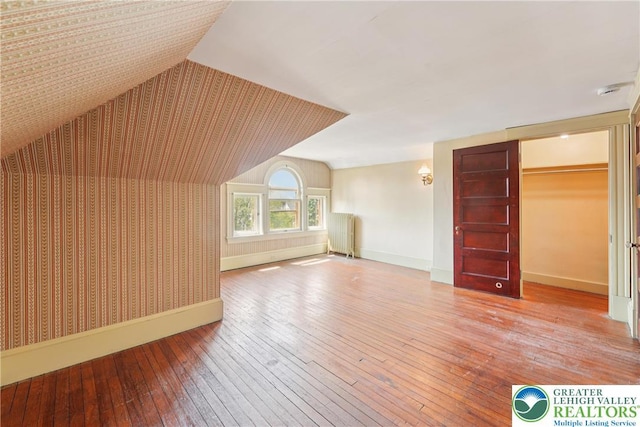 200 W Pierce St, Easton, PA 18042 - additional living space with radiator heating unit, wood-type flooring, wallpapered walls, and vaulted ceiling