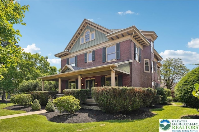 200 W Pierce St, Easton, PA 18042 - view of front facade with brick siding, covered porch, and a front yard