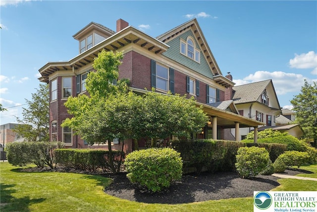 200 W Pierce St, Easton, PA 18042 - view of home's exterior with brick siding, a lawn, and a chimney