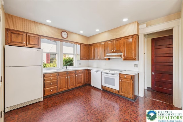 200 W Pierce St, Easton, PA 18042 - kitchen with white appliances, under cabinet range hood, light countertops, brown cabinets, and recessed lighting