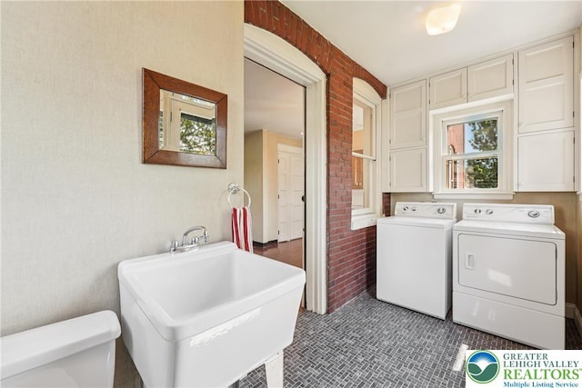 200 W Pierce St, Easton, PA 18042 - laundry room with independent washer and dryer, tile patterned floors, and brick wall