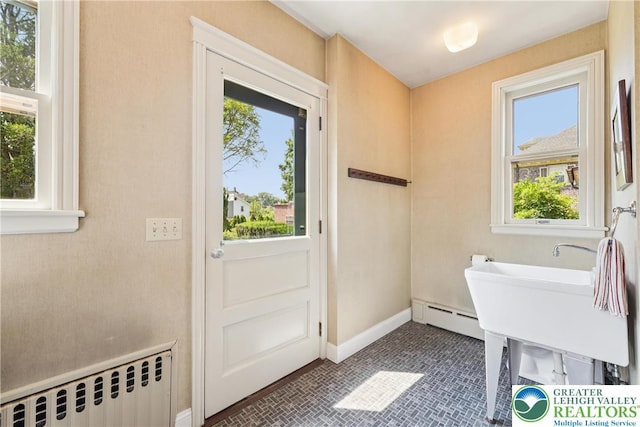 200 W Pierce St, Easton, PA 18042 - washroom with a baseboard heating unit, radiator heating unit, plenty of natural light, and brick patterned flooring