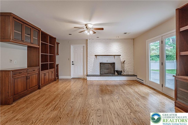 1450 Coventry Rd, South Whitehall Twp, PA 18104 - unfurnished living room with a baseboard radiator, ceiling fan, a brick fireplace, and light wood-style flooring