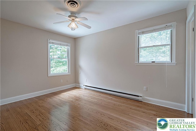 1450 Coventry Rd, South Whitehall Twp, PA 18104 - empty room with a baseboard heating unit, ceiling fan, and wood finished floors