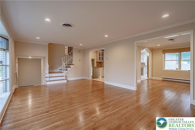 1450 Coventry Rd, South Whitehall Twp, PA 18104 - unfurnished living room featuring a baseboard heating unit, wood finished floors, crown molding, stairway, and arched walkways