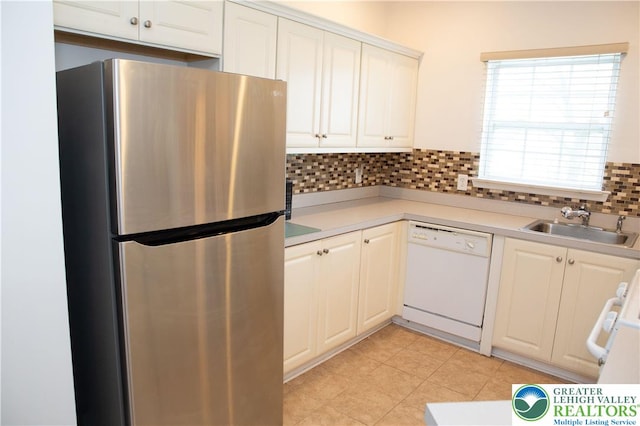607 Prestwick Dr, Williams Twp, PA 18042 - kitchen featuring freestanding refrigerator, dishwasher, light countertops, backsplash, and white cabinetry