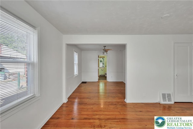 1509 Liberator Ave, Allentown City, PA 18103 - spare room with light wood finished floors, a ceiling fan, and a baseboard radiator