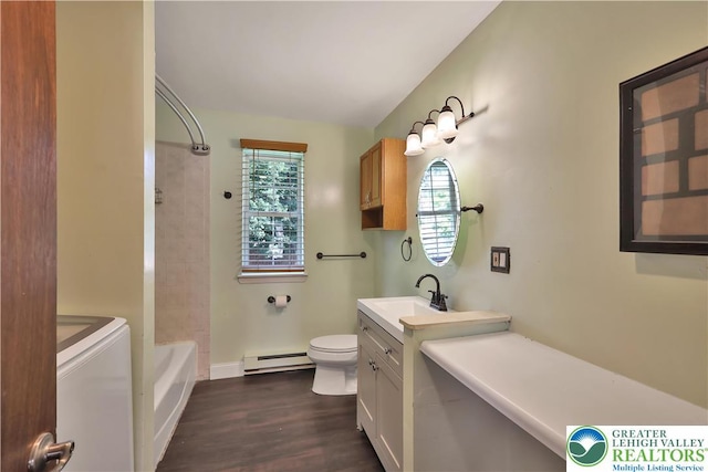 1509 Liberator Ave, Allentown City, PA 18103 - bathroom with washer / clothes dryer, baseboard heating, vanity, wood finished floors, and bathing tub / shower combination